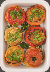 Colored stuffed peppers with potato, carrot, garlic, onion and parsley. Healthy food and dieting concept, top view.