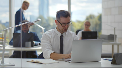Young businessman concentrate on working with laptop computer at office