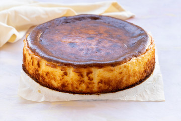 San Sebastian Cheesecake on White Wood