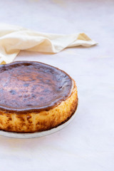 San Sebastian Cheesecake on White Wood