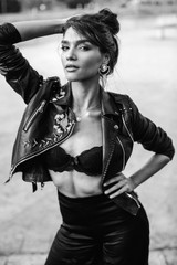 Fototapeta na wymiar Beautiful woman posing in black leather jacket
