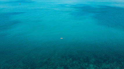 Beach and bright blue sea, high angle view