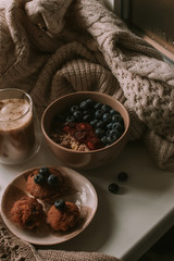 Breakfast with granola, eggs, coffee and cakes