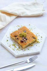 sherbet kadayif dessert on white wood