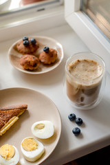 Breakfast with granola, eggs, coffee and cakes
