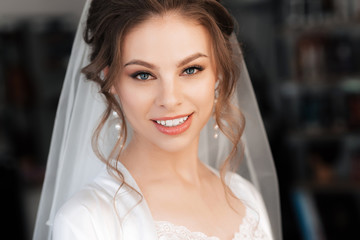 Naklejka premium portrait of a beautiful bride with makeup and hair styling smiling