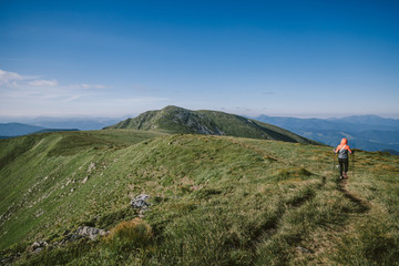 Naklejka premium A group of people walking on a grassy hill