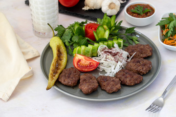Delicious Turkish traditional kebab meatballs on white plate. Turkish Food Kofte or Kofta (meatball).