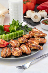 Chicken wings on the grill. Grilled chicken wings on a white background