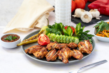 Chicken wings on the grill. Grilled chicken wings on a white background