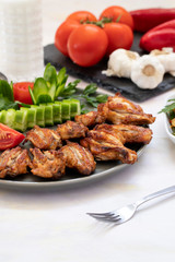 Chicken wings on the grill. Grilled chicken wings on a white background