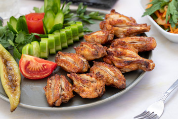 Chicken wings on the grill. Grilled chicken wings on a white background