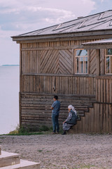 wooden historical house near the sea with people 