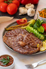 Isolated grilled beef steak on a wooden board