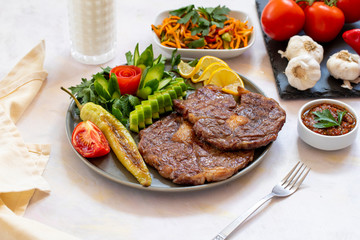 Isolated grilled beef steak on a wooden board