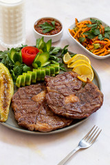 Isolated grilled beef steak on a wooden board