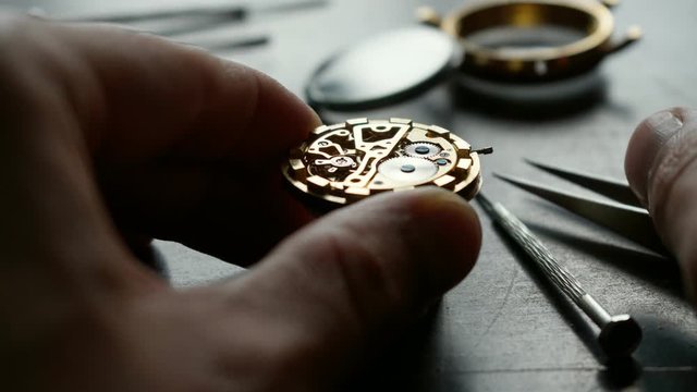 Watchmaker is repearing mechanical wrist watch