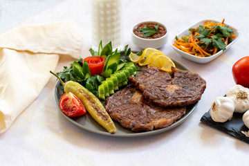 Isolated grilled beef steak on a wooden board