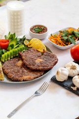 Isolated grilled beef steak on a wooden board