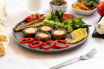 cheddar mushrooms - baked cheddar mushrooms on a white background