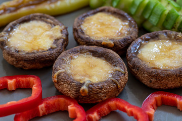 cheddar mushrooms - baked cheddar mushrooms on a white background