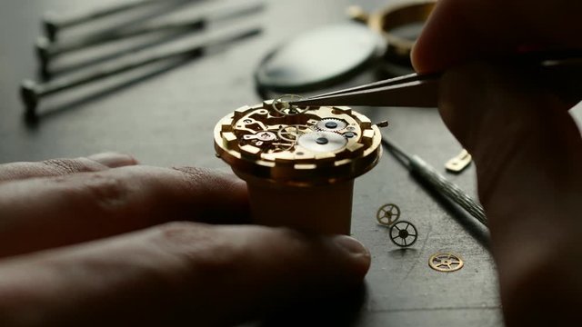 Watchmaker is repearing mechanical wrist watch