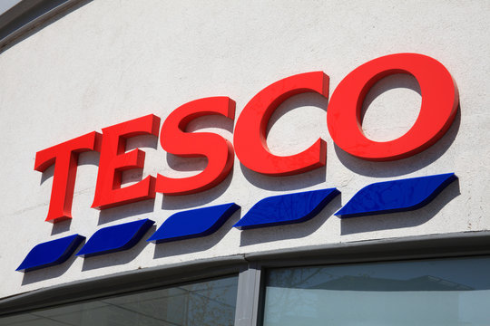Portsmouth, United Kingdom, April 22, 2011 : Tesco logo advertising sign outside its business retail supermarket store in Portsmouth city centre stock photo