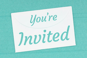 You’re Invited word message on white envelope