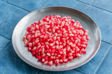 Pomegranate grains on a plate, stock photo