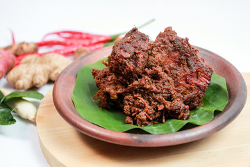 Rendang meat. A very popular Padang or West Sumatra dish. The photo is taken from the side with white isolated and bokeh.