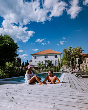 French Vacation Home With Wooden Deck And Swimming Pool In The Ardeche France Europe. Couple Relaxing By The Pool With Wooden Deck During Luxury Vacation At An Holiday Home In South Of France