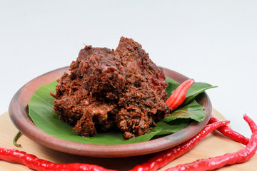 Rendang beef. A very popular Padang or West Sumatra dish. The photo is taken from the side with white isolated.