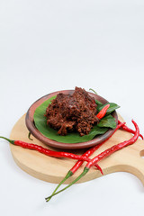 Rendang meat. A very popular Padang or West Sumatra dish. The photo is taken from the side with white isolated.
