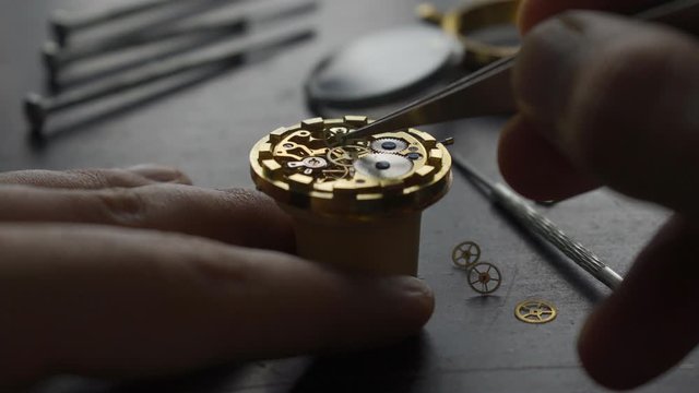 Watchmaker is repearing mechanical wrist watch