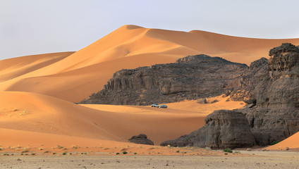Fototapeta na wymiar SAFARI ACROSS DESERT DUNES IN TADRART NATIONAL PARK IN ALGERIA. TIN MERZOUGA SAND DUNES. 