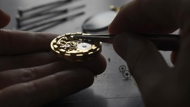 Watchmaker is repearing mechanical wrist watch