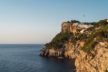 Fototapeta na wymiar View from a viewpoint at Soller (Serra de Tramuntana, Mallorca, Spain) of a cliff and a luxury hotel on the top of it