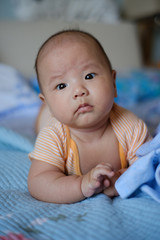 baby boy lay on the bed