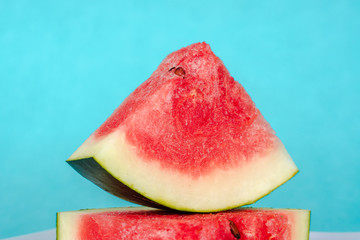 Water melon slices on blue background. Stock photo