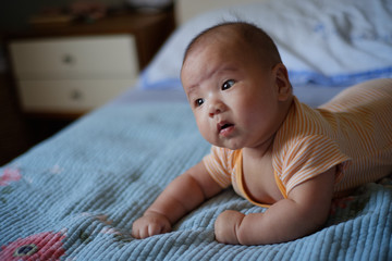 baby boy lay on the bed