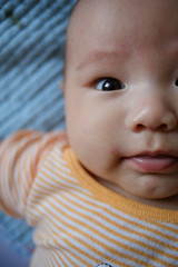 baby boy lay on the bed