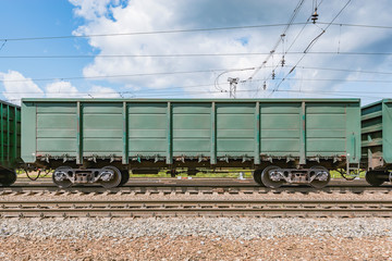 Freight carriages stand on the station before departure.