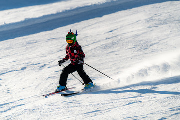 Fototapeta na wymiar Happy Boy with Ski Helmet and Googles on a Ski Slope