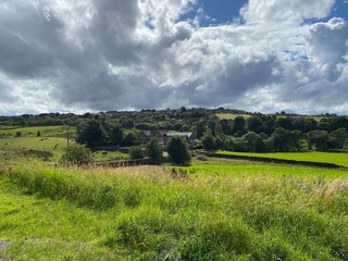 Obraz premium Landscape view, of fields, long grasses, farm buildings, on a cloudy day near, Bradford, Yorkshire, UK