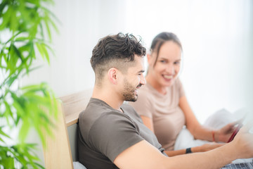 couple working on bed with laptop and tablet, work from home concept