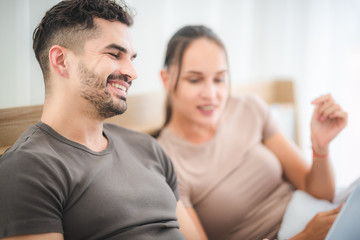 Obraz premium couple working on bed with laptop and tablet, work from home concept