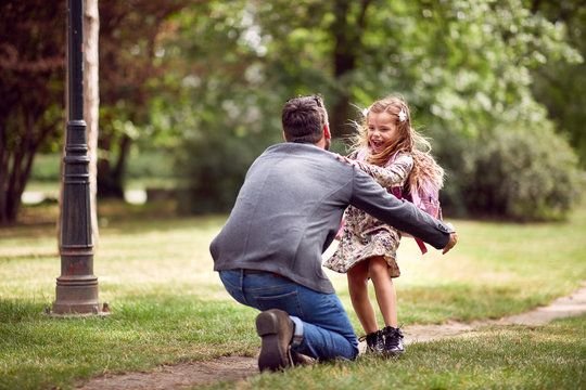 Dad Embracing Daughter After School