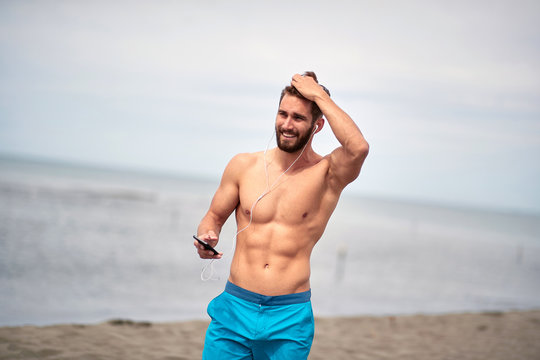 Attractive Man Walking On The Beach; Hot Guy Concept