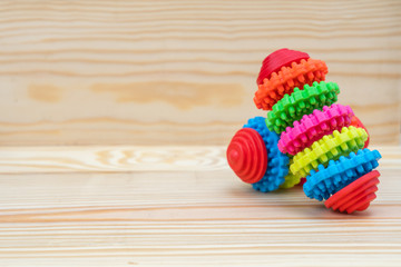 Pet toy of rubber with copy space on wooden background