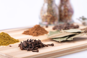 Spices and seasonings on a wooden Board on a white background.